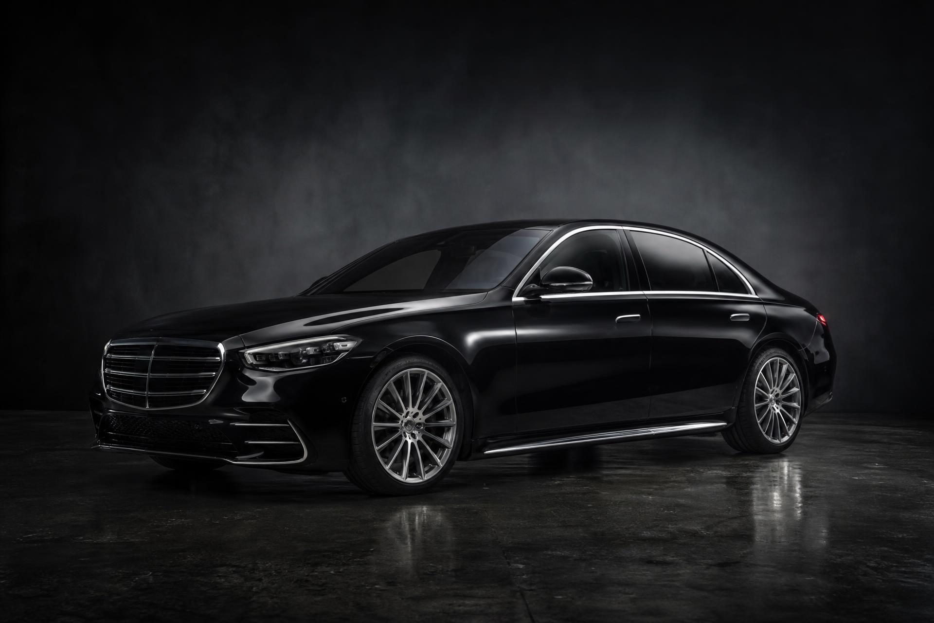 Black luxury sedan under dramatic studio lighting